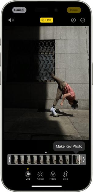 iPhone screen showing a live photo of a person doing a backflip.
