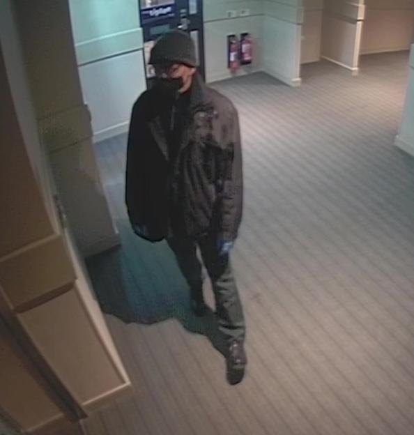 Thomas Kwan in a face mask and gloves leaving a Premier Inn hotel.
