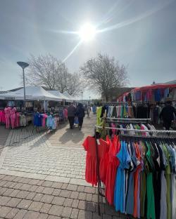 Outdoor market selling clothing.