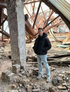 A man standing in a war-damaged building in Kyiv, Ukraine.