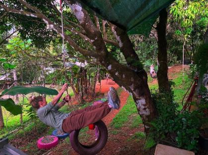 Woman swinging on tire swing in Costa Rica.