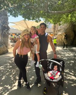 Family of four at a zoo.