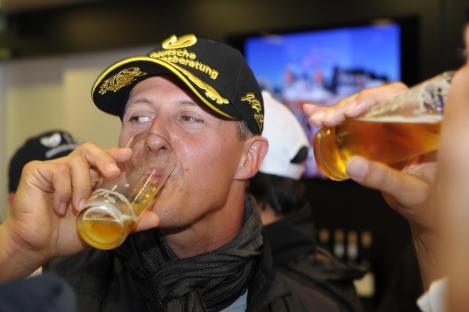 Michael Schumacher drinking beer at his anniversary party.