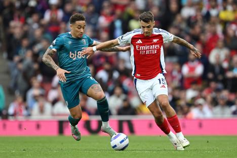 Arsenal's Jakub Kiwior running with the ball during a match.