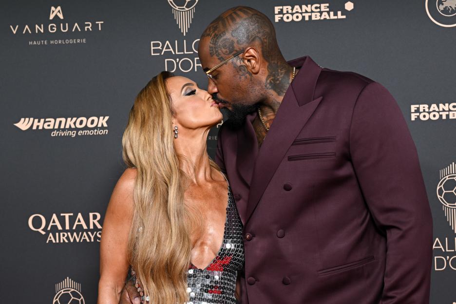 Kate Scott and Malik Scott kissing at the 69th Ballon D'Or Photocall.