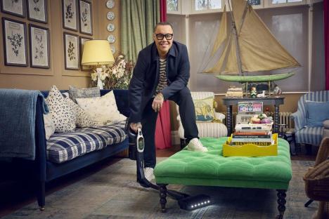 Man vacuuming in a living room.