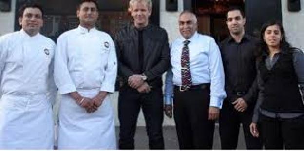 Group photo of Gordon Ramsay with the owners of a Southall restaurant.