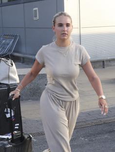 Molly Mae and Tommy Fury arriving at an airport.