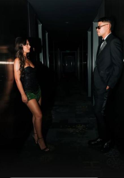 Conor and Megan in a dimly lit hallway.