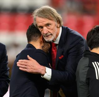 Sir Jim Ratcliffe consoling Ruben Amorim after a soccer game.