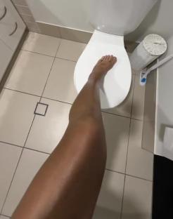 Leg resting on toilet seat with text overlay: