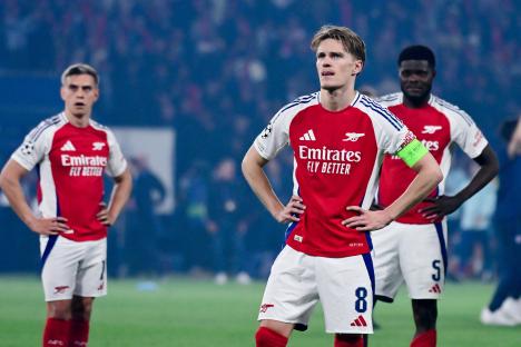 Dejected Arsenal FC players after a Champions League match.