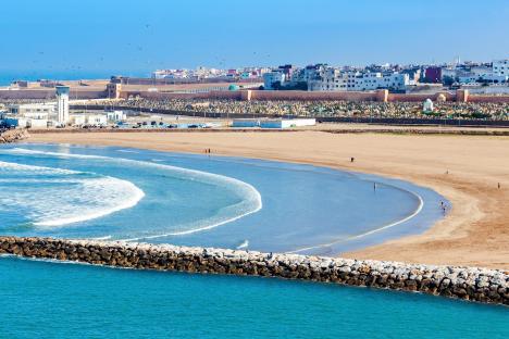 Aerial view of Rabat beach in Morocco, showing the Kasbah of the Udayas fortress and a cemetery.