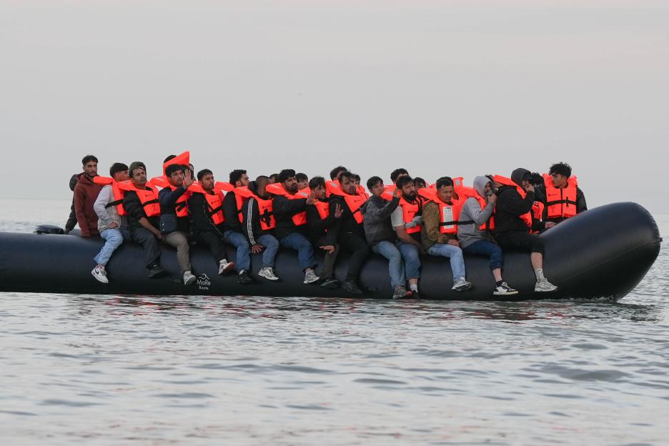Migrants in life vests aboard an inflatable boat.
