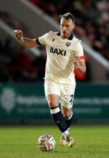 Sam Long of Oxford United running with the ball during a soccer match.