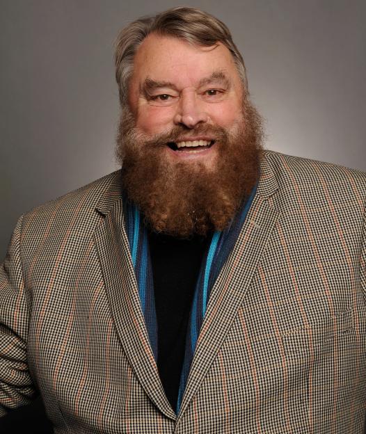 Portrait of Brian Blessed smiling.