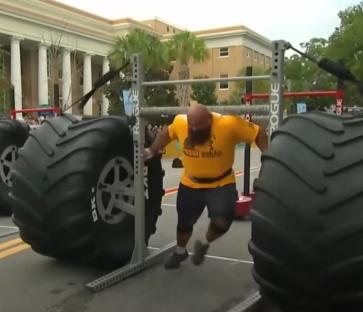 Strongman competitor pulling a large tire.