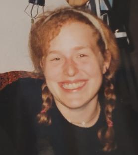 Photo of a young woman with pigtails and a headband.