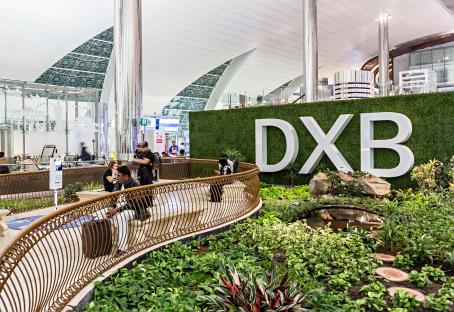 DXB airport transit area with a garden.