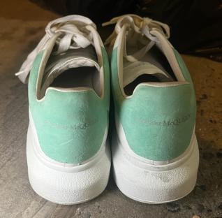 Pair of mint green and white Alexander McQueen sneakers.