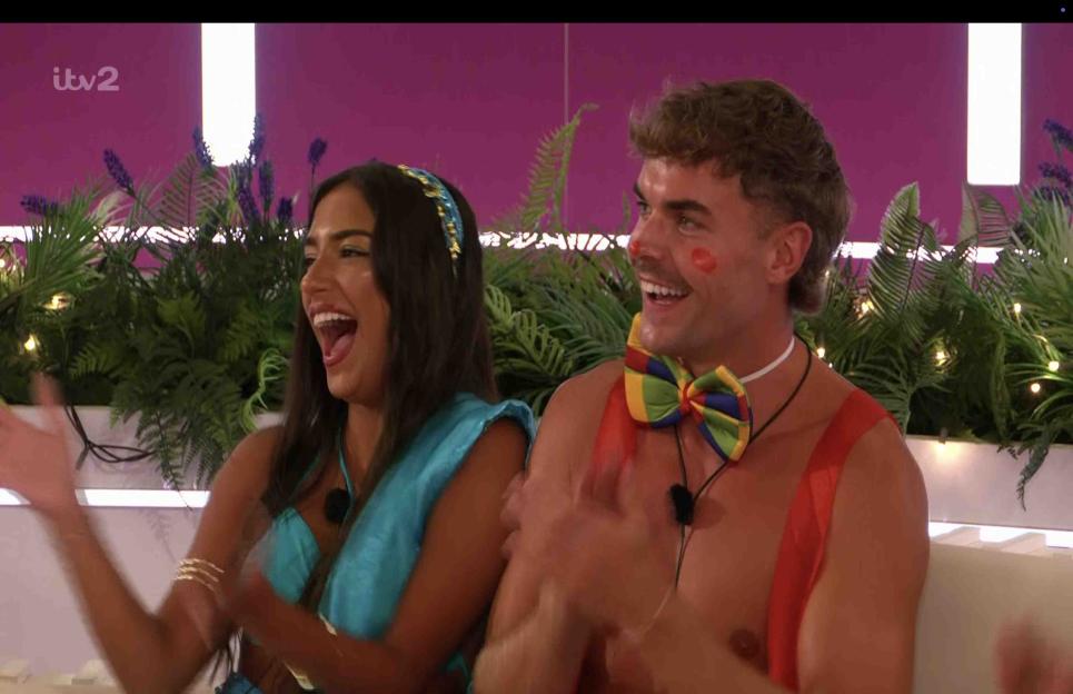 Love Island contestants clapping.