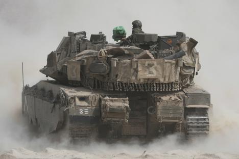 Israeli soldiers operating a tank near the Gaza Strip border.