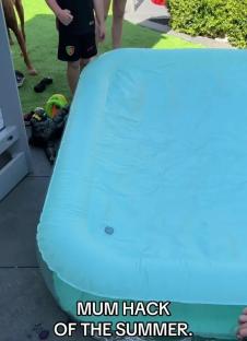 Inflatable paddling pool being inflated with a hairdryer and empty bottle.