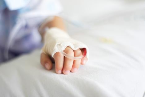 Child's hand with an IV drip.