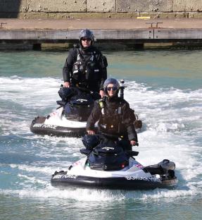 Two Border Force officers on jet skis.