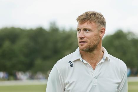 Freddie Flintoff in a white cricket shirt.