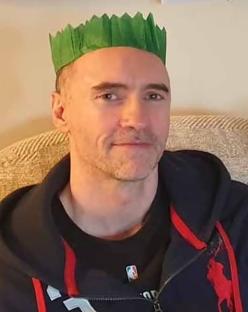Paul Doyle wearing a green paper crown.