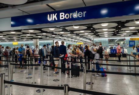 Passengers waiting in line at UK Border Control in Heathrow Airport Terminal 5.