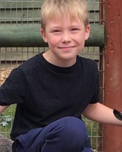 Photo of a young boy smiling.