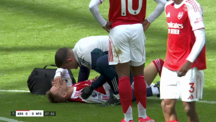 Soccer player receiving medical attention on the field.