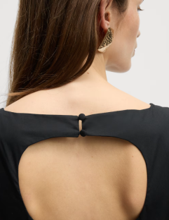 Model wearing a black midi dress with a keyhole back.