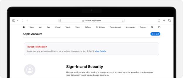 Apple account threat notification on laptop screen.