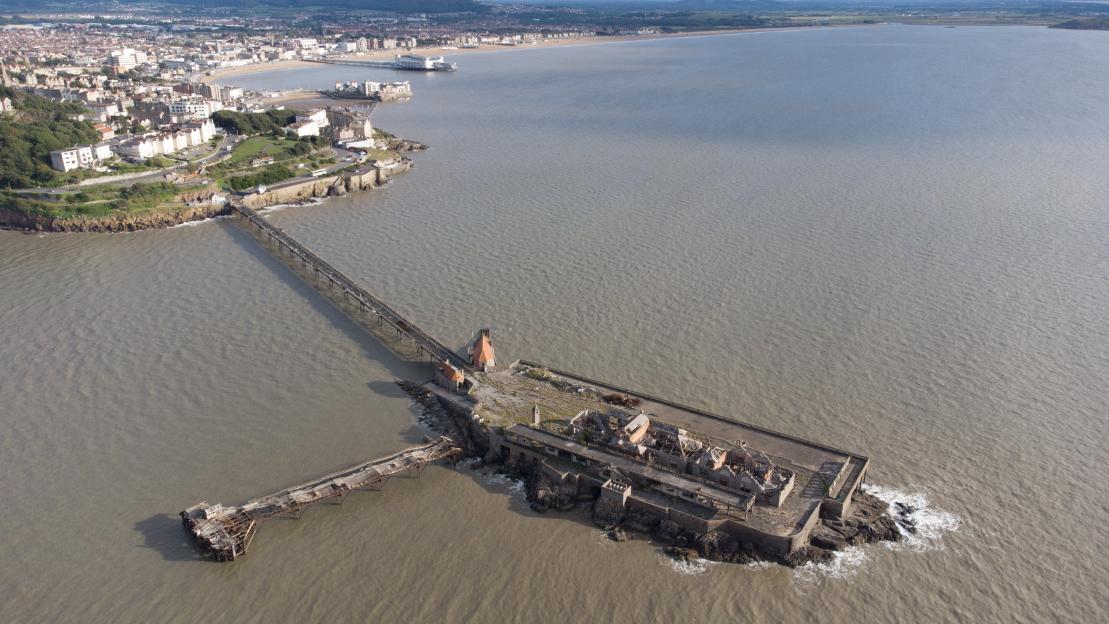 Aerial view of the ruined Birnbeck Pier in Weston-super-Mare, England.
