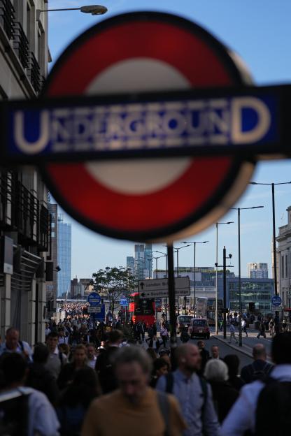 Crowds of commuters walking across a bridge in London during a Tube strike.
