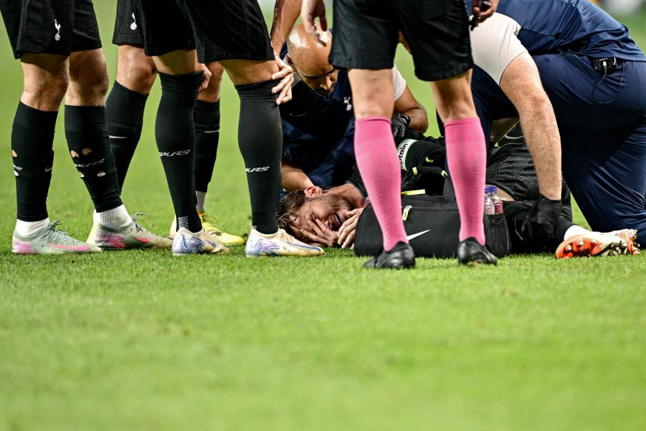 Injured soccer player being attended to on the field.