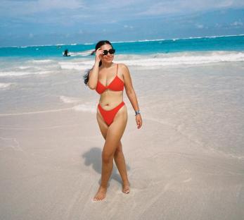 Woman in red bikini on a beach.