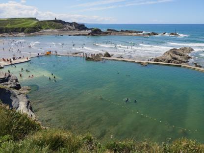 Aerial view of Bude sea pool with people swimming.