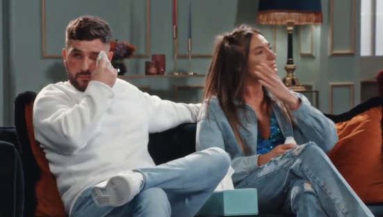 Kristina and Kieran crying on a couch.