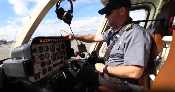 Pilot in helicopter cockpit.