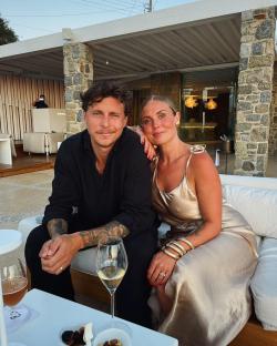 Couple sitting together outdoors at a resort.