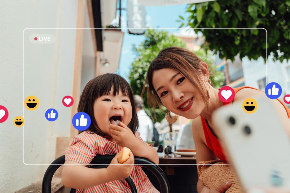 Mother and daughter livestreaming on a smartphone.