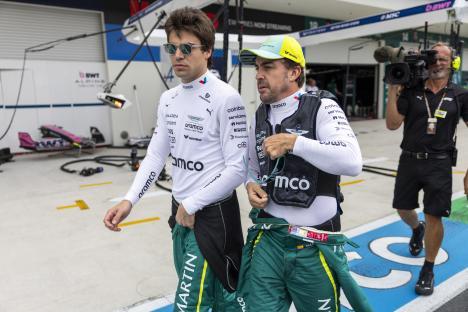 Fernando Alonso and Lance Stroll walking to the grid before a Formula 1 race.