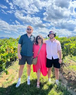 Sam Gardiner with his mother and brother in a vineyard.