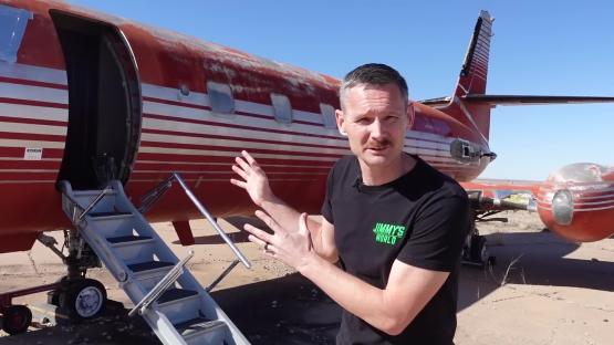 A man stands in front of Elvis Presley's private jet.