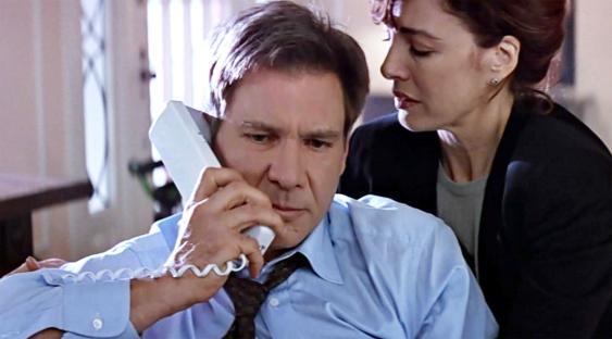 Still from Clear and Present Danger (1994) showing Harrison Ford on a phone call with Anne Archer.