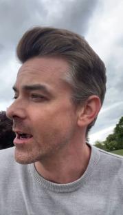 Man speaking outdoors.